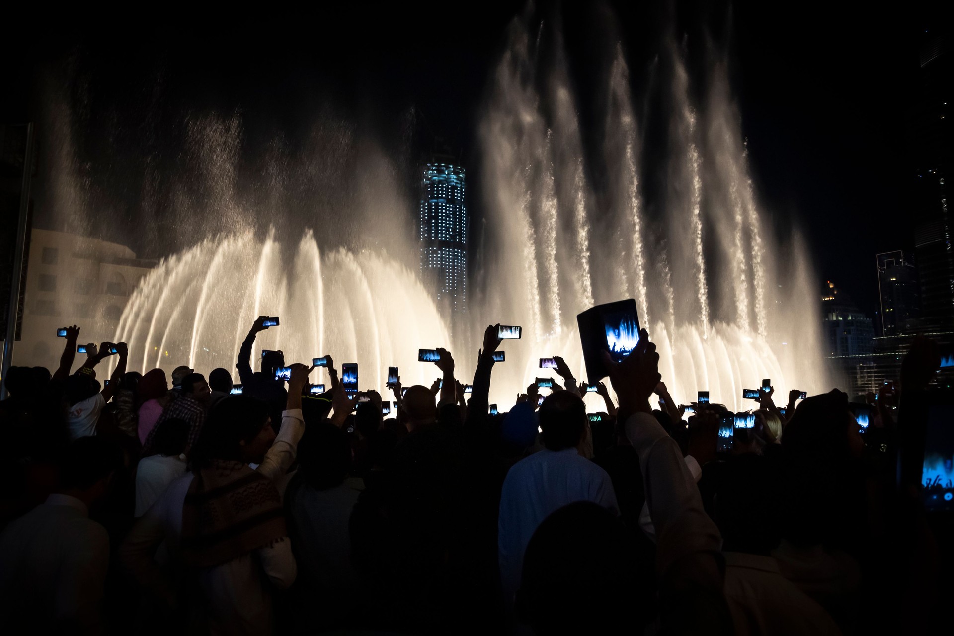 Tourists take pictures of the singing fountains